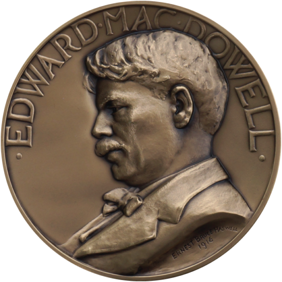 The Edward MacDowell Medal. A gold plated coin features a bas relief profile of Edward MacDowell with his name above.
