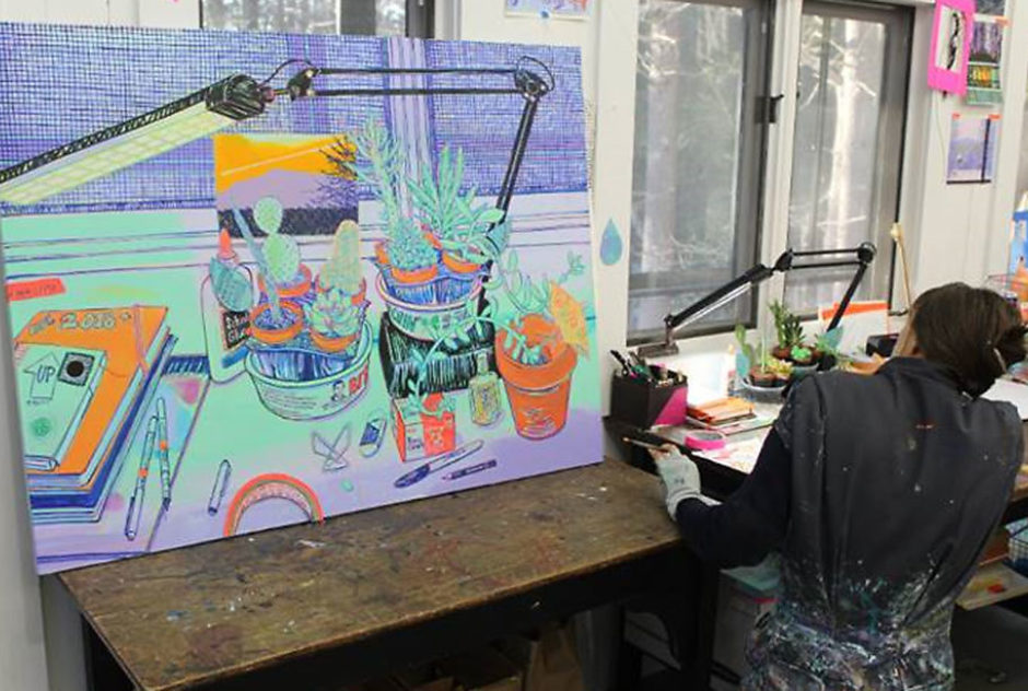 Fellow Hope Gangloff works on a large painting at her desk in her studio