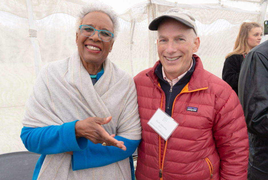 Madam Chairman Nell Painter and board member Scott Manning smile for a photo inside the tent at the New Hampshire Benefit in May 2022