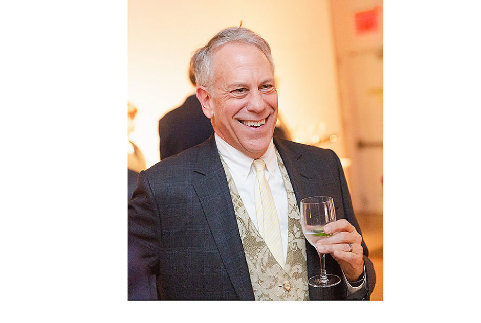 Philip Himberg smiles and holds a drink in this candid shot