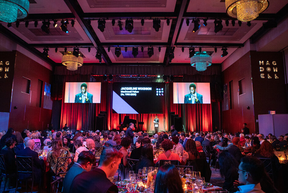 Evening host, MacDowell Fellow, and award-winning author Jacqueline Woodson (4x, 90-09) welcomes the crowd to the Ziegfeld Ballroom. (Marc Goldberg Photography)