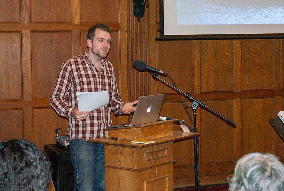 Fellow Ben Mauk presents at a podium during a MacDowell Downtown event