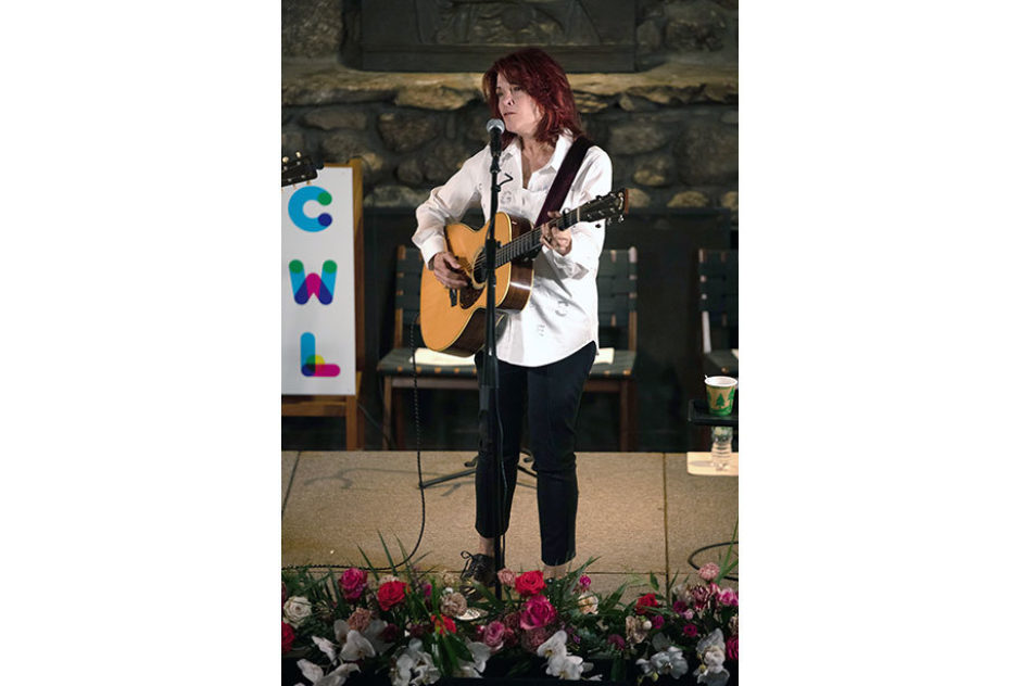 Roseanne Cash performs on stage in Bond Hall. She is playing the acoustic guitar and singing