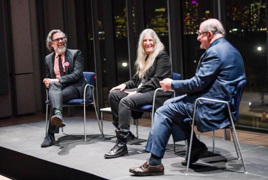 Michael Chabon, a woman, and Salman Rushdie sit together on a stage for panel discussion