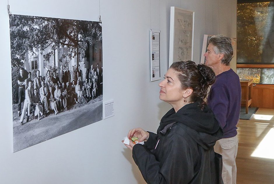 Two people admire a photograph hung on a wall