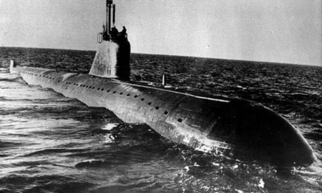 Black and white photo of a submarine partially submerged in the ocean
