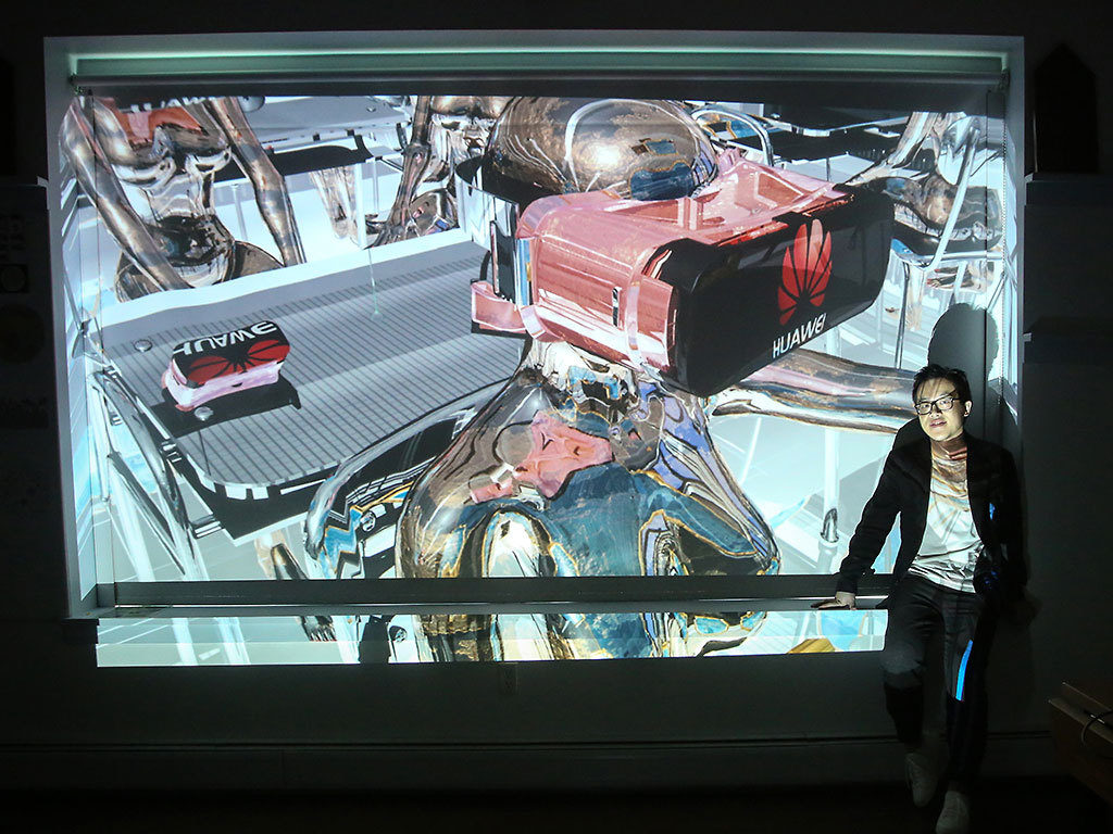 Fellow Ziyang Wu standing in front of a projection of her artwork