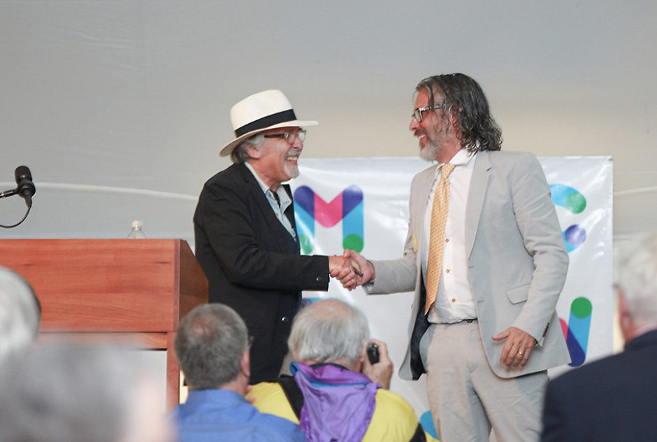 Art and Michael shake hands and smile brightly as Art receives the Edward MacDowell Medal