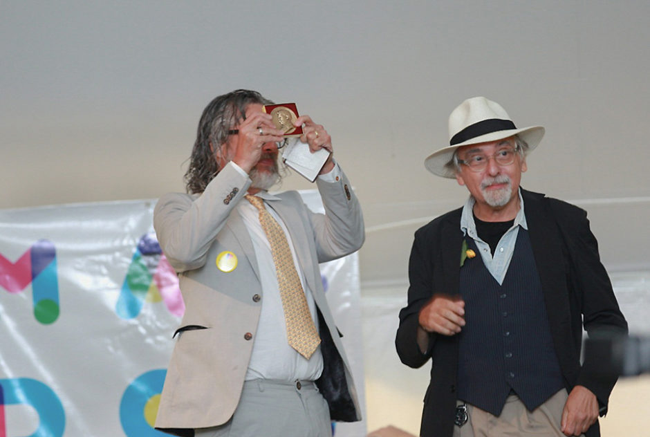 Michael Chabon holds the Edward MacDowell Medal up high as he stands with the recipient, Art Spiegelman