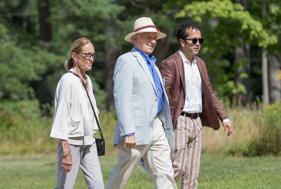 Friends walk together along one of the paths on the MacDowell grounds during the studio tours part of Medal Day