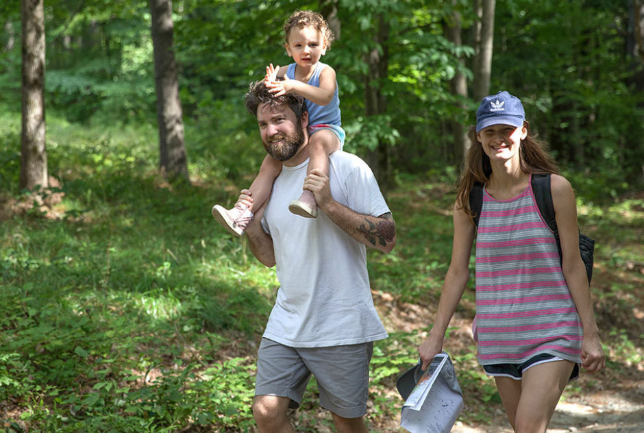 A family walks together along one of the paths on the MacDowell grounds during the studio tours part of Medal Day