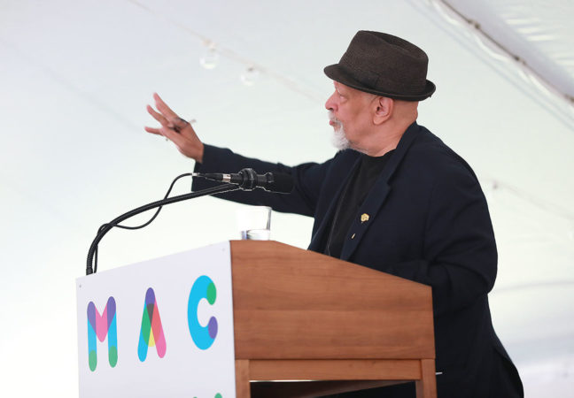 Speaker and MacDowell Fellow Walter Mosley gestures from the podium during his introduction of 62nd Edward MacDowell Medalist Sonia Sanchez.