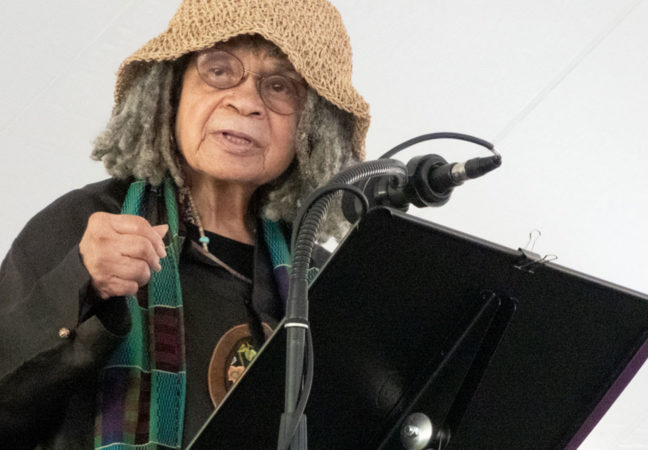 Sonia Sanchez addresses the crowd on July 10, 2022 from the stage under the Medal Day tent.