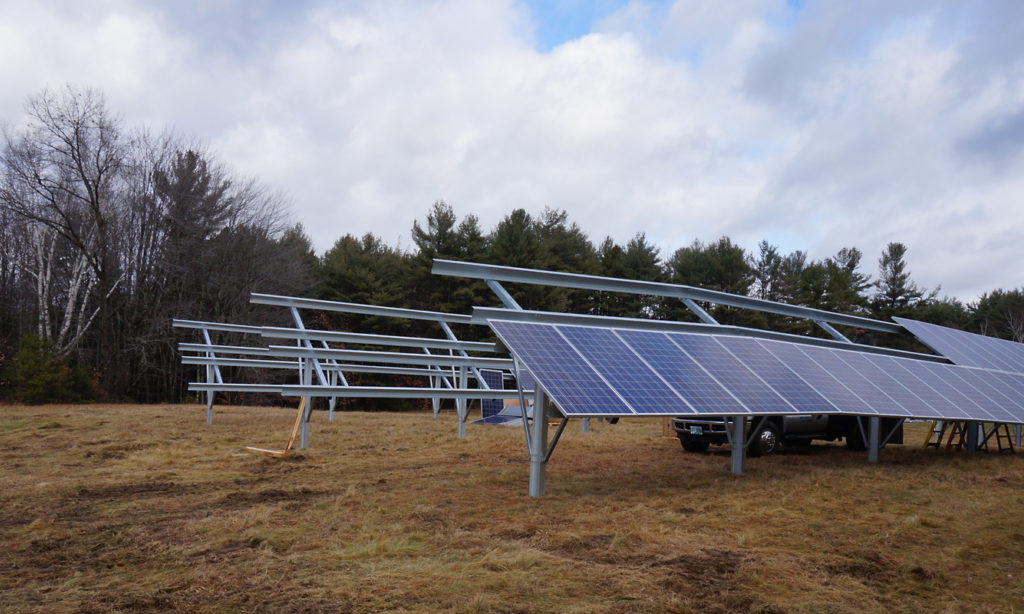 Solar panels being installed on large metal structures