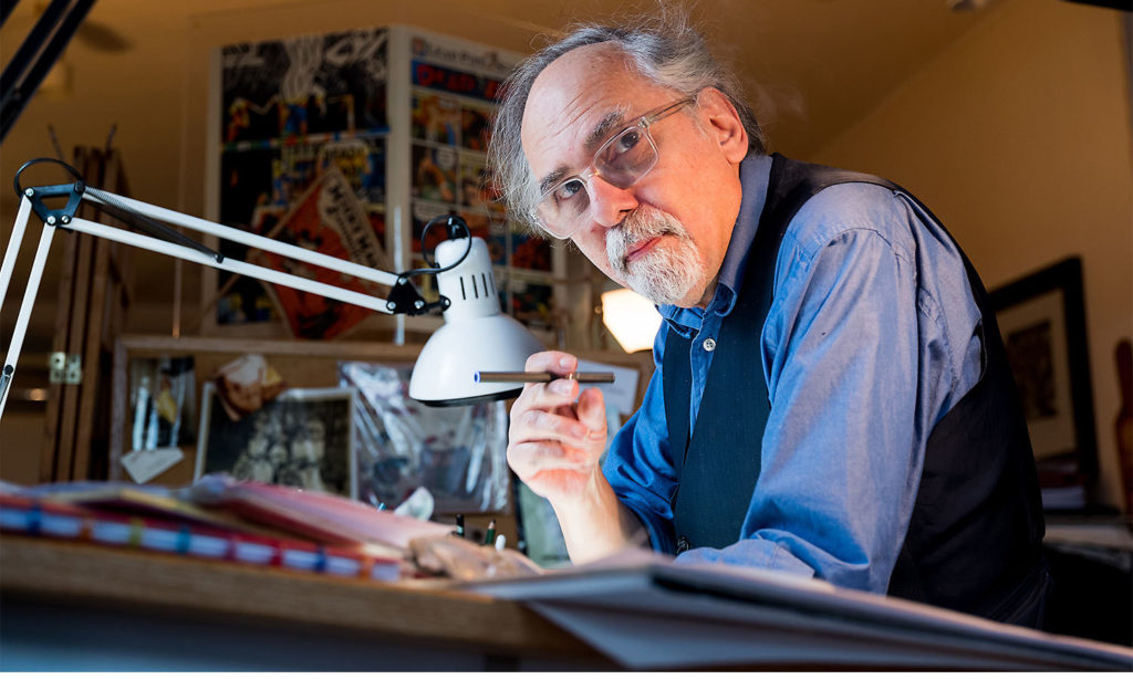 Portrait of Art Spiegelman working at his desk.