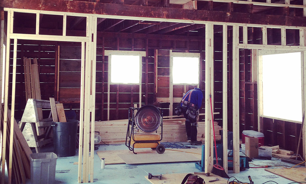 Interior of Delta Omicron studio during renovation. The floor, walls and ceiling are all bare, awaiting insulation and sheetrock