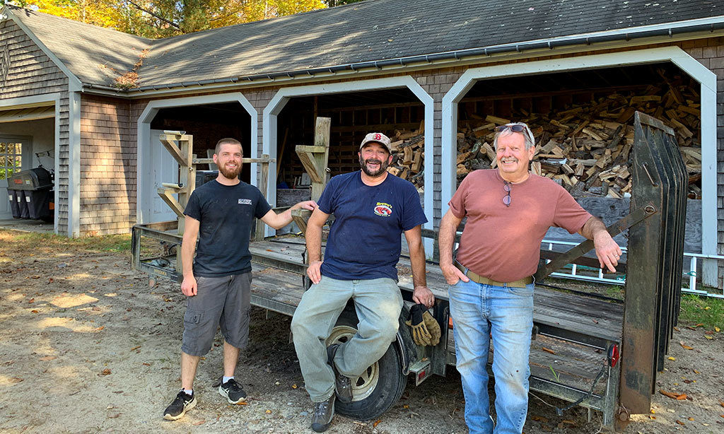 MacDowell Gardener &amp; Maintenance Assistant Dan Thayer, Assistant to Maintenance Foreman Jamie Sargent, and Maintenance Foreman John Sieswerda in front of the woodshed they built from timber harvested from the MacDowell property.