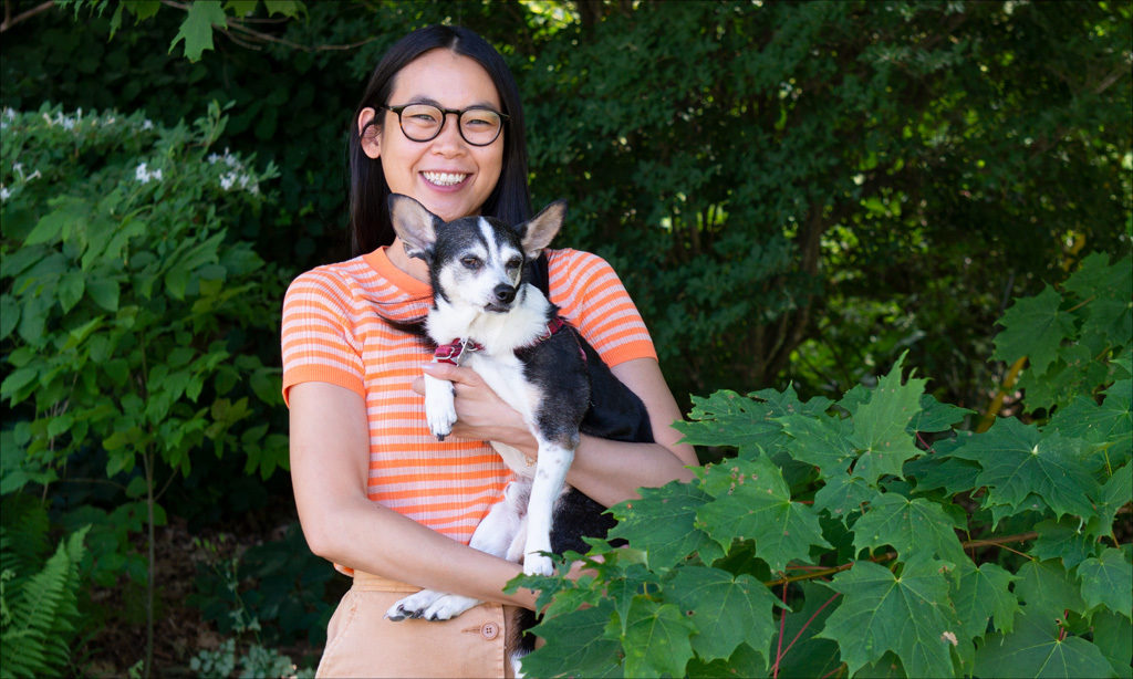 MacDowell Director of Internal Communications &amp; Human Engagement Jenni Wu amid the summer foliage at MacDowell with her dog, Marvin.