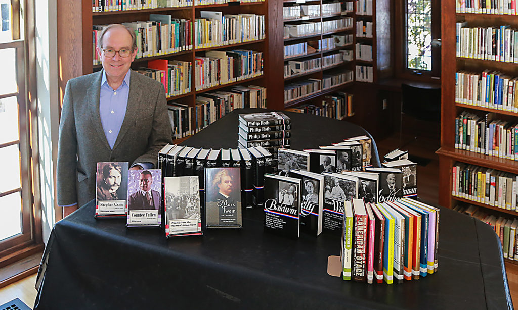 MacDowell Board Member Peter Jachym with the Library of America donation in Savidge Library.