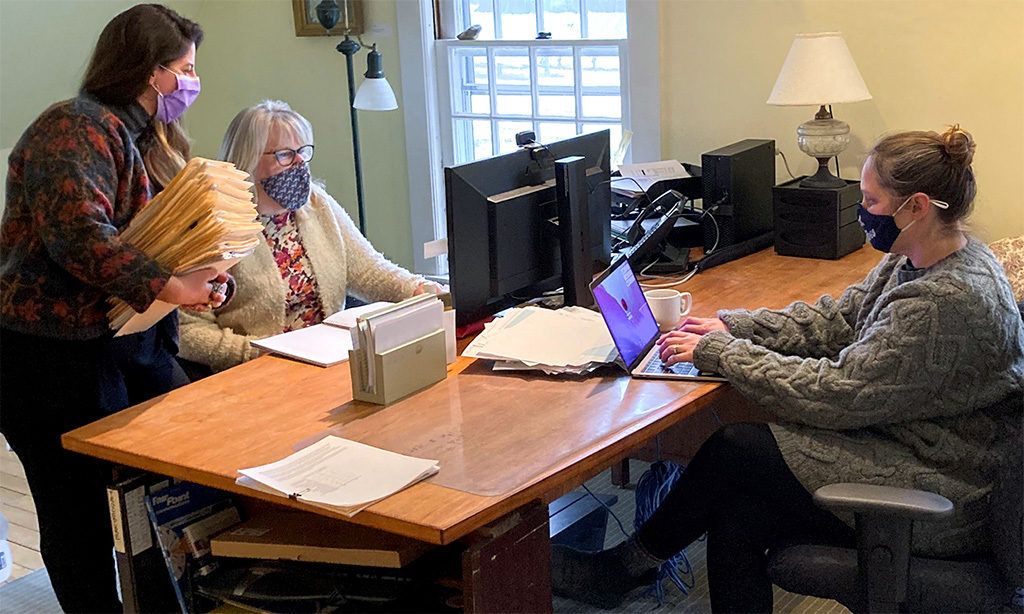 MacDowell's Admissions Assistant &amp; Administrative Assistant Sarah Jordan, Admissions &amp; Scheduling Coordinator Karen Keenan, and Admissions Director Courtney Bethel huddle in late March 2022.